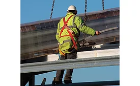 A Construction Worker Protected by a Guardrail and a Fall Arrest System