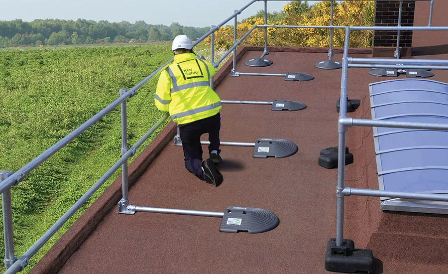safety-rail-source-KeeGuard_PVC_man_walking_on_roof.jpg