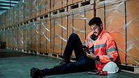 worker on his phone on the jobsite