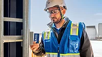 construction jobsite access construction worker swiping his ID at a jobsite