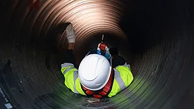 worker in tunnel wearing high-visibility clothing