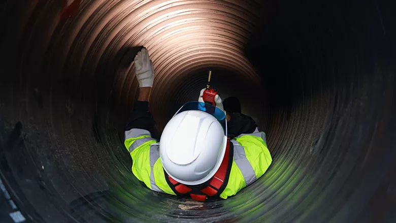 worker in tunnel wearing high-visibility clothing