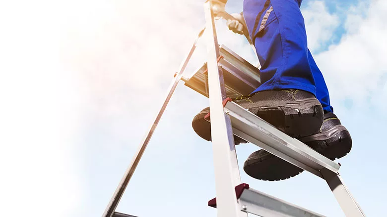 worker on a portable ladder