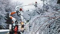 workers servicing an electrical utility line in the winter