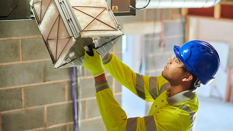 man inspecting filter