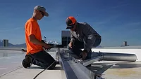 two men installing a permanent fall protection system