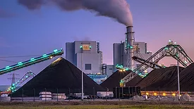 a coal-fired power station, a type of industrial facility that burns coal to produce electricity
