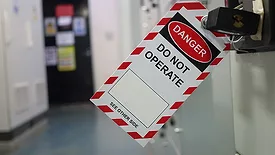 This is a lockout tagout (LOTO) safety tag used to prevent machinery from being energized during maintenance