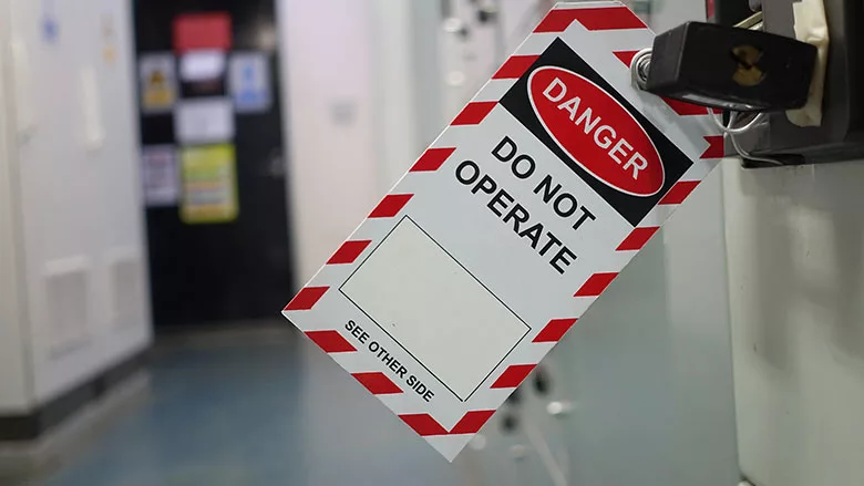 This is a lockout tagout (LOTO) safety tag used to prevent machinery from being energized during maintenance