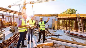 men working on a construction site in the summer heat