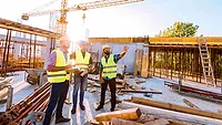 men working on a construction site in the summer heat