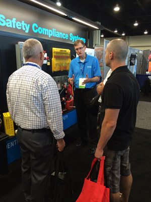 Mark Evans, Territory Manager for Master Lock Company, explains some of the recent Safety products to a pair of booth guests at the VPPPA Expo.