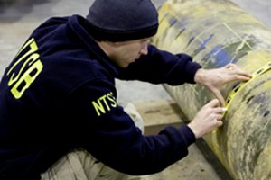 NTSB senior materials engineer Don Kramer identifies a section of pipe to be cut and removed for further examination at the NTSB's lab in Ashburn, Va.