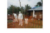 MSF health staff in protective clothing constructing perimeter for Ebola isolation ward.